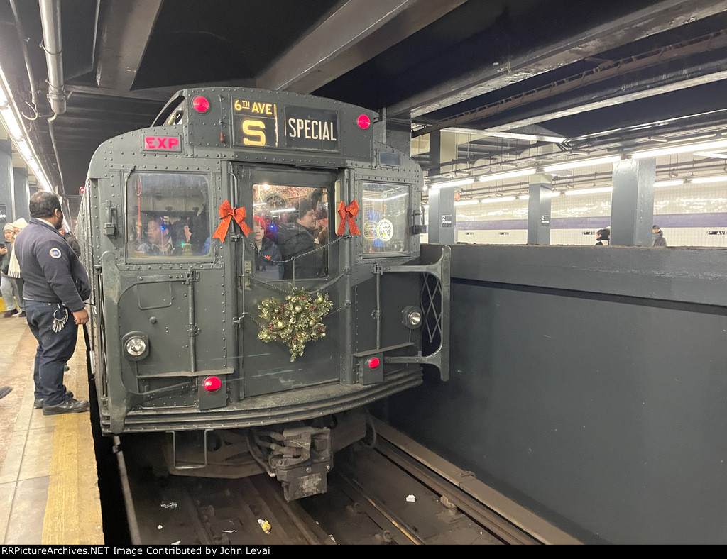 An MTA Employee talking to the motorman of the holiday train just before departure from 2nd Avenue Station 